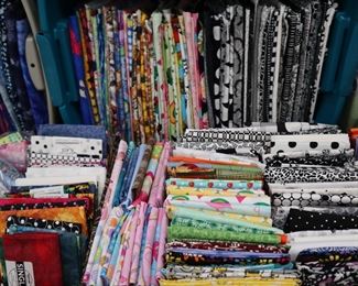 Quilting cottons in yardage, half yards, fat quarters, remnants and smaller pieces.  Some Batiks.  Wonderful variety of brands and styles. Some of the themes include cats, sports, holiday, Halloween, cartoons, MOD style, etc.