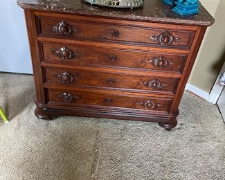 Chest with marble top. More perfumes. Foo dogs