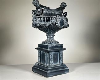 Composition Jardiniere | Italianate composition urn / jardiniere with putti. - l. 11 x w. 9 x h. 19 in