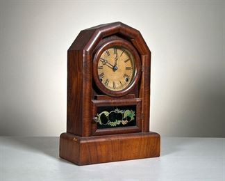 Shelf Clock | Roman numeral face, pendulum and key included, glass dial door and reverse painted door frame; maker unknown. - l. 9.5 x w. 4.5 x h. 14 in