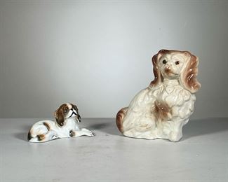 (2pc) Porcelain Dog Figures | Two porcelain King Charles cavalier dog figures, one with impressed stamp mark "CH 116" and blue underglaze mark. - l. 7 x h. 7.5 in (larger)