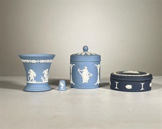  (4pc) Wedgwood Pieces | Four piece Wedgwood England blue and white matte finish Greco-Roman motif collection, includes: angel motif cup; lidded jar with muse motif; round lidded box with Pegasus motif; and a thimble. - h. 4.25 x dia. 3 in (lidded jar)