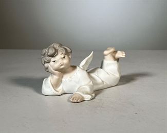 Lladro Angel Figure | Lladro angel laying down figurine; matte porcelain finish; signed on bottom, #9. - l. 5.5 x h. 2.5 in