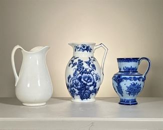 (3pc) Blue & White Jugs | Lot of three large pitchers: one blue and white W H Grindley Co. Osborne jug; one blue floral hand painted Portuguese pitcher signed on bottom; and one large unmarked white jug. - h. 12 in (Osborne pitcher)