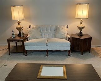 White loveseat has a matching couch and chair. The 3 wooden pieces coordinate. 2 matching leaded lamps.