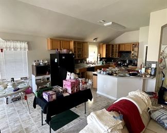 Kitchen is full of Pyrex, Tupperware, glassware, serving dishes, pots & pans, vintage working microwave & refrigerator