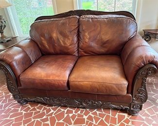 #18 Ashley leather loveseat 68" $100.00