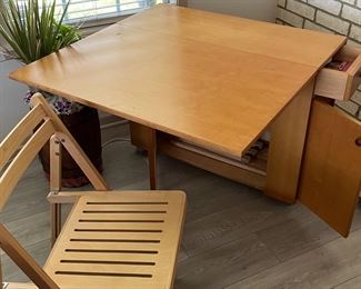 4 chairs match and are stormed in this mid century drop leaf table