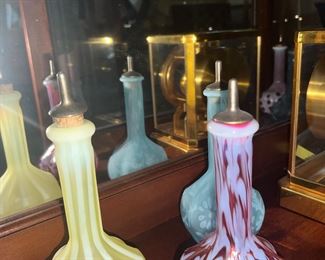 Fenton cranberry daisy and fern barber bottle ($100), yellow Vaseline barber glass ($150), and Blue Opalescent bottle ($100)