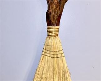 Large carved man with broom skirt