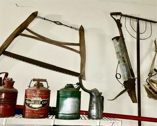 Antique saw, misc. planting items, metal gas cans