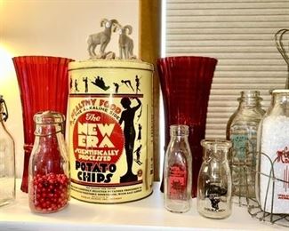Close-up view of several advertising milk bottles, New Era potato chip tin, etc. (SOME SOLD)