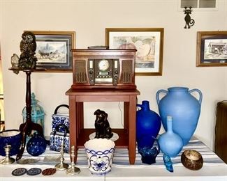 Vintage prints, wooden plant stand, wooden side table, replica of a vintage record player/radio, blue ceramic pots, Delft planter, blue & white collectibles