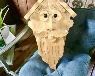 Carved man bird house