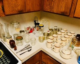 Assortment of drinking glasses, coffee cups, jars, canning.