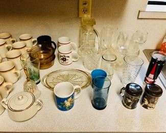 Assortment of drinking glasses, coffee cups.