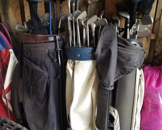Several sets of golf clubs