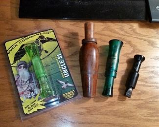 Uncld Si duck call, wooden duck call, Primos 'Power Owl' turkey call, and P.S. Olt crow call
