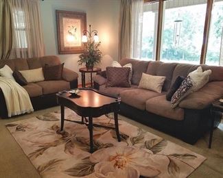 The living room features a matching sofa and loveseat
