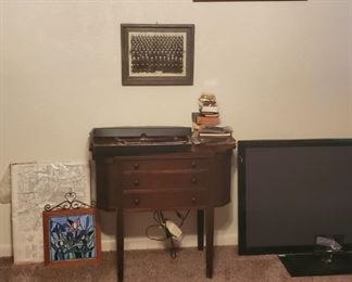 Antique sewing machine in cabinet
