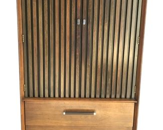 $1000 USD     Lane Tower Suite Mid Century Walnut/Rosewood Armoire Highboy Dresser CJ173-1    Description:  Wonderful mid century walnut and rosewood armoire manufactured by Lane Furniture in United States, circa 1970s. Features an innovative design where the blind-shaped doors stand out, allowing us to see the quality of the rosewood grains through its structure. Open the doors to two full size pull-out drawers, and above these, we have two open compartments suitable for extra storagte. The lower portion houses two large dovetail drawers with aesthetically constructed pulls. It is important to mention that it still has the original manufacturer's stamp. Due to its versatile size, it allows it to work in small spaces while having great functionality.
Dimensions: 34 wide x 19 deep x 60 inches high
Condition: Used in excellent vintage condition with only minor signs of wear commensurate of age and use. 
Local pick up Clifton, VA.  Contact us for shipper suggestions.      https://goodb