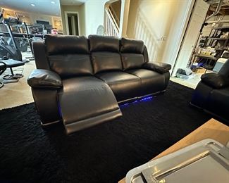 Black duel reclining sofa with under seat lighting