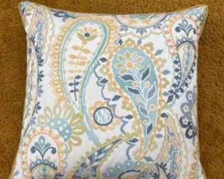 Decorative pillow in blue, beige, gold, and navy