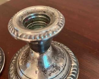 Silver goblets, silver candle holders and silver serving piece