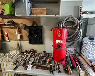 Shop vacuum with attachments, vintage tools, bucket, miter box, US flags, Husker flags.