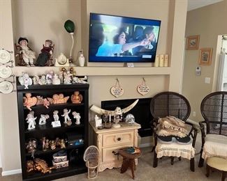 Wicker chairs, foot stools. 48" Samsung Smart TV. Snow angels, lots of other collectibles. Carved tusk. Black shelf is also for sale.