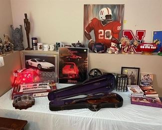 Original Johnny Roger art, other Husker items, Elvis's collectible tin, violin, train set.