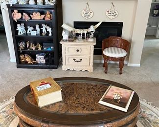 Mid-Century hand carved Asian table w/6 nesting stools. Large area rug. original oil on canvas framed art, Black bookcase loaded with collectibles. Websters dictionary. 