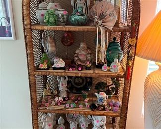 Lots of collectibles including Buddhas, candles, covered dishes.