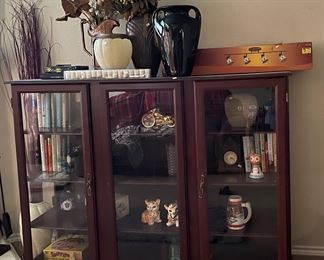 Cabinet. Items inside sold separately. Books games. Decor. Vases and lighting above also for sale