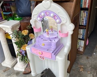 Kids toys and plant stands. Book shelf.