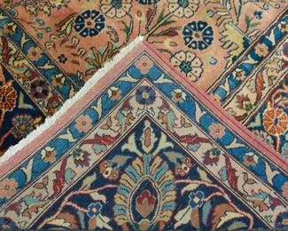 Showing the underside of the semi-antique Persian Sarouk room size rug measuring about 8' by 10' in excellent overall condition with very minor OLD moth damage on one end.  Overall a gorgeous rug with a wonderful sheen.