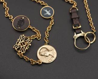 Detail on long vintage Juicy Couture charm necklace