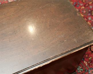 Small 20th century chest or stand in a Chippendale Style measuring 23" across, 15 1/2" deep, and  22" tall with a lovely patina and typical signs of wear from age and use.