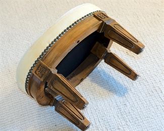 Petite oval needlepoint stool measuring 16" long, 12" deep, and 11" tall, in excellent vintage condition.