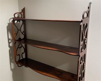 c. 1940's/1950's hanging wall shelf in mahogany, with plate grooves, measures 24" long, 25" tall, and 6" deep.