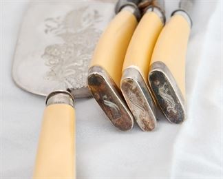 Detail on the carving set with celluloid handles and a crumber without a brush.