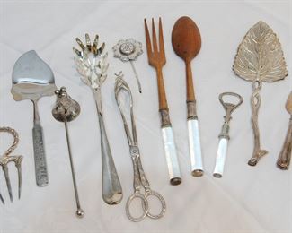 Large collection of eleven silver plated utensils and serving pieces including a roast holder, cheese slicer, candle snuffer, pasta spoon, tongs, tea strainer, Lucite handled salad servers, Lucite handled bottle opener, leaf form server, and a pastry server.
