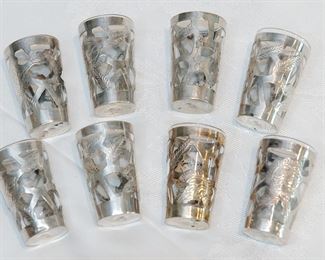 Set of eight shot glasses in Mexican sterling silver holders.