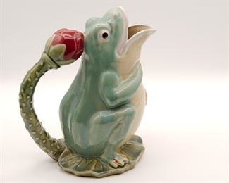 Contemporary majolica style figural frog ewer on lily pad with lotus blossom handle, 9 1/2" tall.