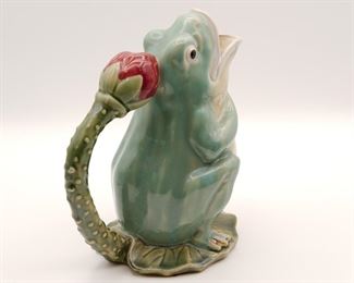 Contemporary majolica style figural frog ewer on lily pad with lotus blossom handle, 9 1/2" tall.