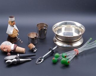 Fun selection of vintage and antique barware including bottle coaster, shot glasses, corks and bottle stoppers, corkscrew, olive server, and figural glass swizzle sticks