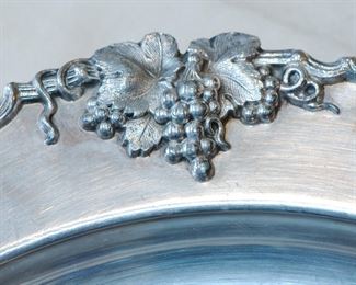 Detail on the large round silverplate grape pattern serving tray