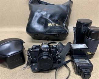 Nikon EM Film Camera With Nikon Series E 50mm 1:1-8 and Quantaray Auto 200mm 75-200mm 1:4.5 Macro Lens, Sunpak Flash and Nikon Leather Bag
