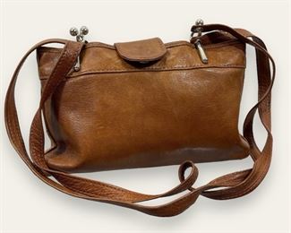 Camel colored Italian leather handbag with silver hardware, two straps and snap closure
