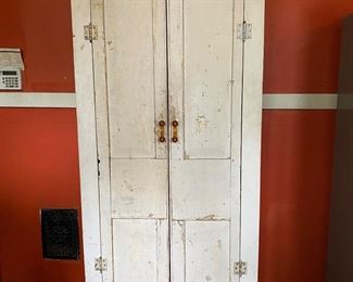 Off-white, primitive cabinet with shelves & glass pulls, constructed with antique architectural pieces.